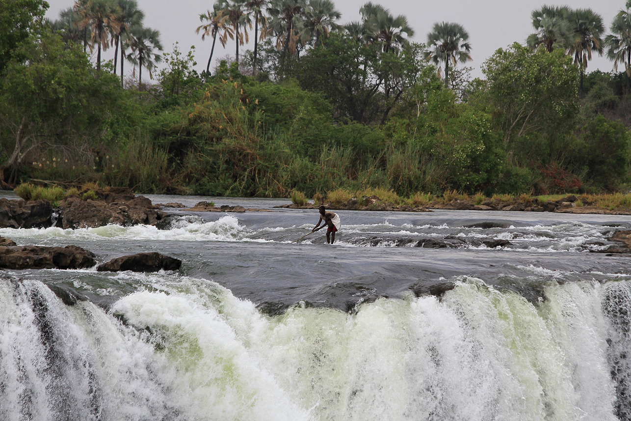 Fisherman on top of the falls