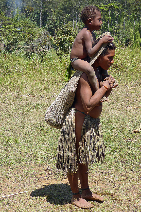 One child in the sack and one on the shoulders