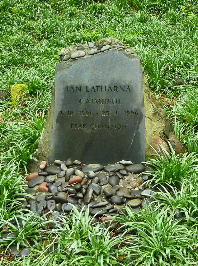 Grave of the former owner of the island (John Lorne Campbell in English) in the field of blue bellies in the wood