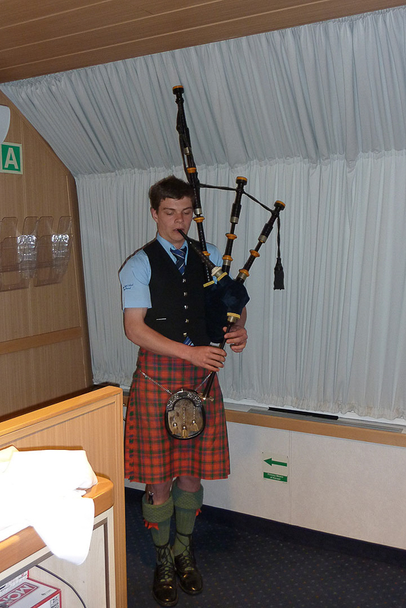 Angus, 16 years old, playing bagpipes on arrival to Oban