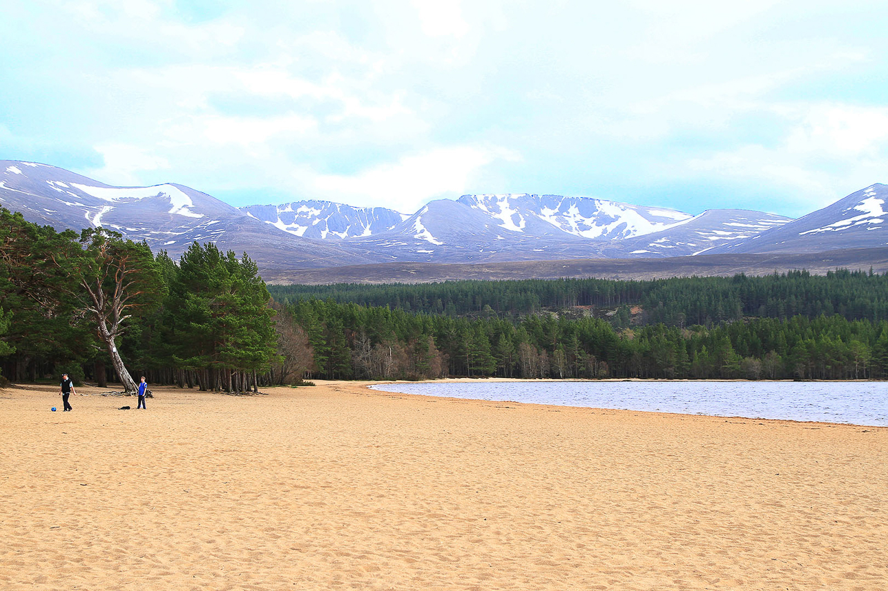 Loch Morlich, with the Cairngorm mountains behind. Still some skiing in mid April.