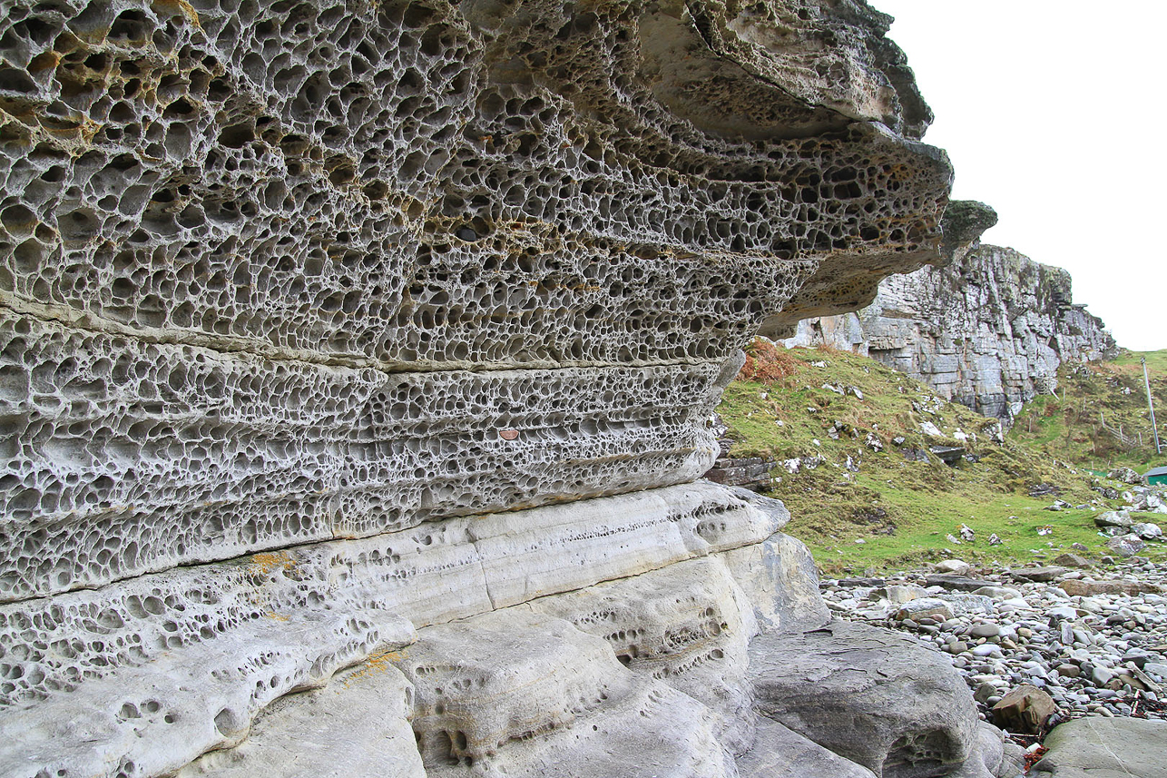 Sandstone cliffs perforated like honeycombs