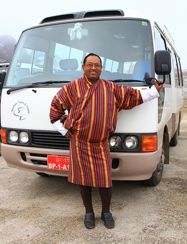 Traditional clothing (gho) for official persons. Here our bus driver.