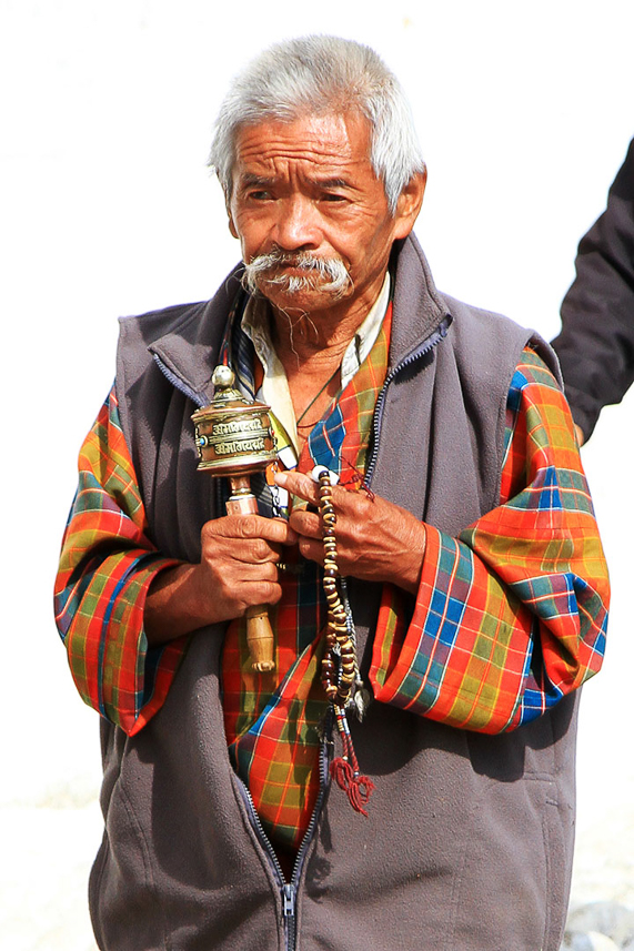 Old man performng the kora.