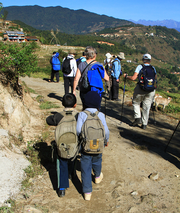 Walking along the small road.