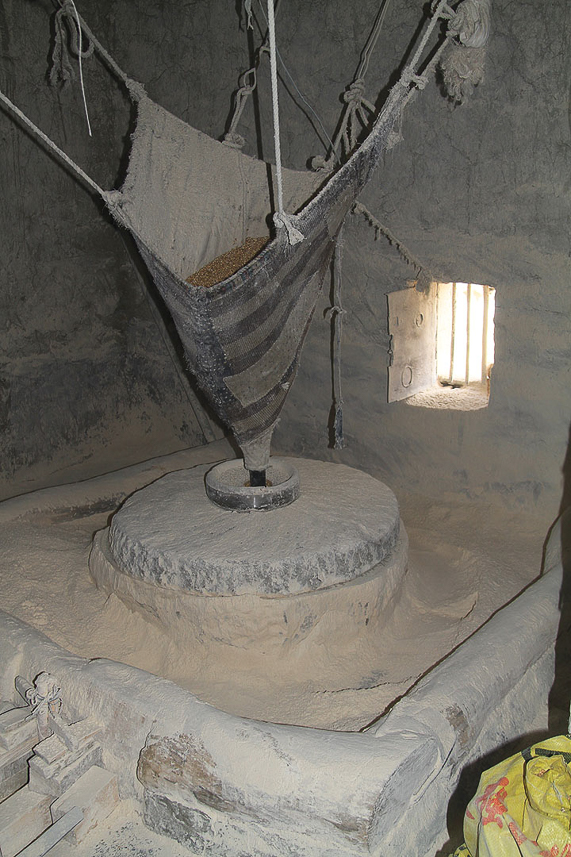 Making barley flour inside a water driven mill.