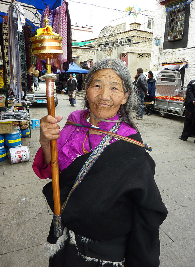 Old woman with prayer wheel, walking the Johkang kora.