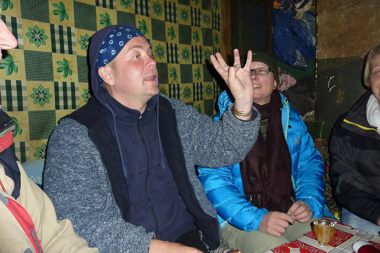 Peter ordering chang (barley, hot water, yeast, a relative to beer)  at a local bar in Gyantse.