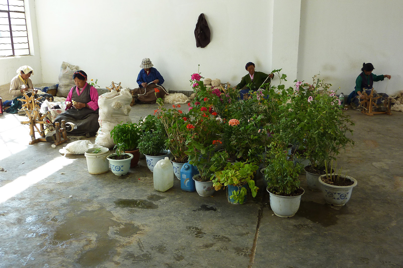 Carpet factory in Shigatse. Sitting on the floor, except when weaving.