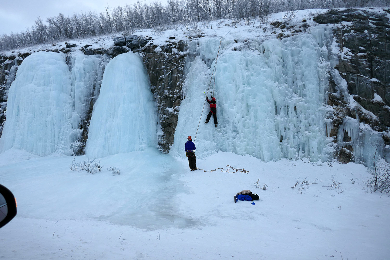 People testing ice climbing close to the road