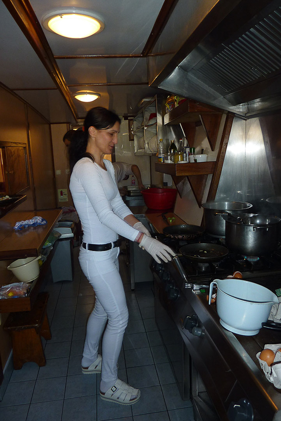 Preparing food in the small kitchen on the ship.