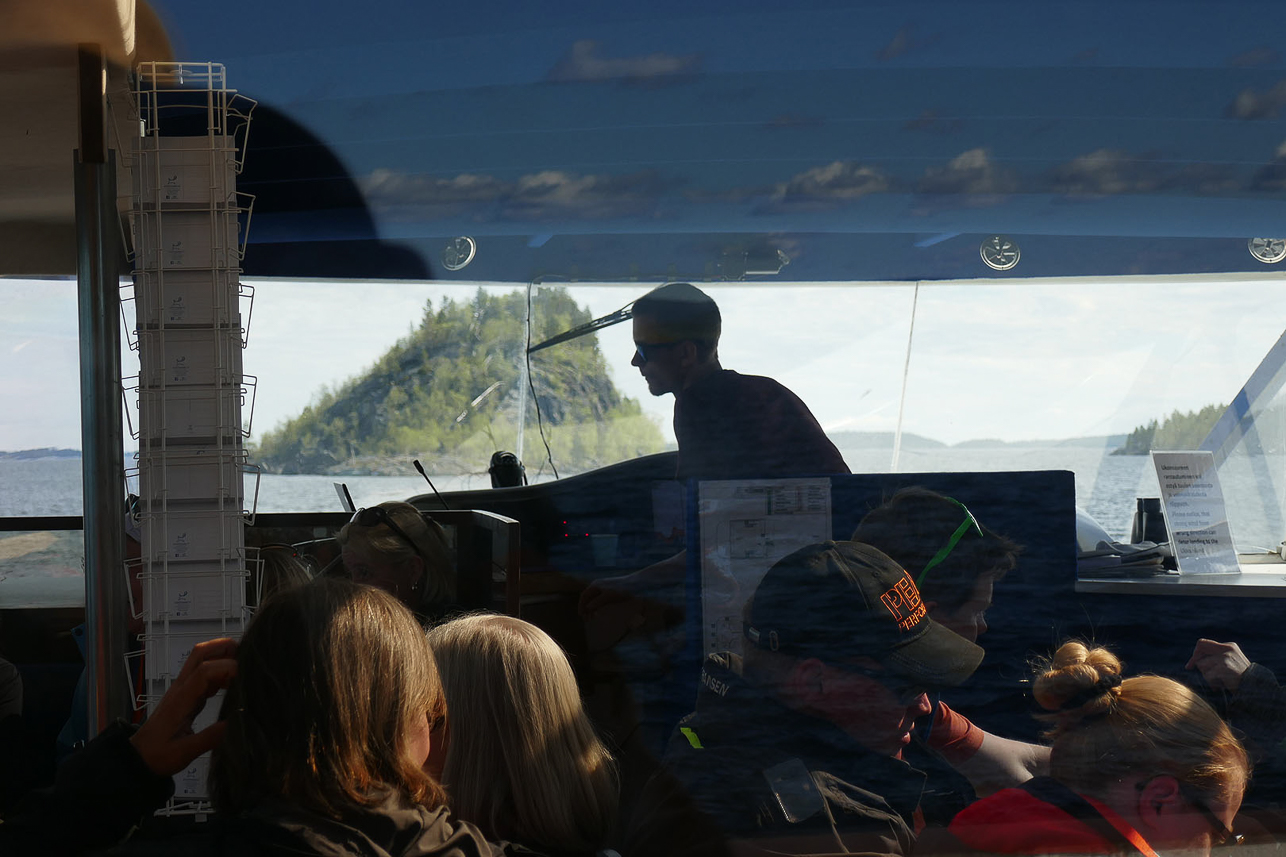 Boat trip to Ukonkivi (Ukko's Rock) on island of Ukonsaari in Lake Inari