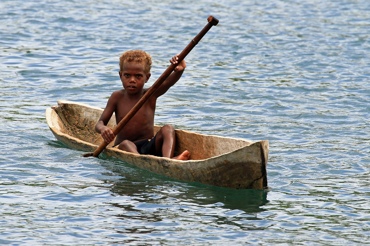 Small boy in a canoe.