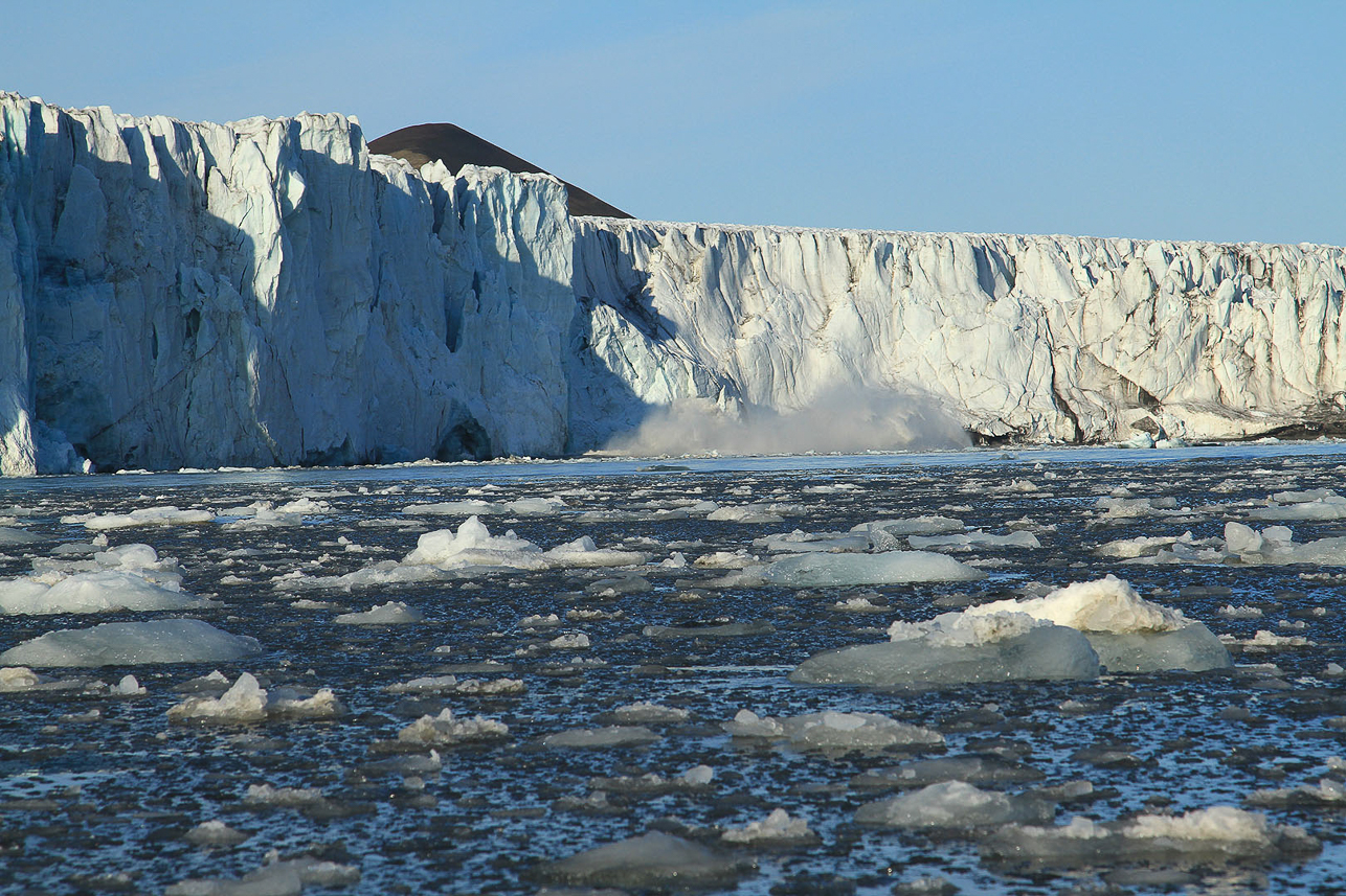 Ice falls into the water with a heavy sound.