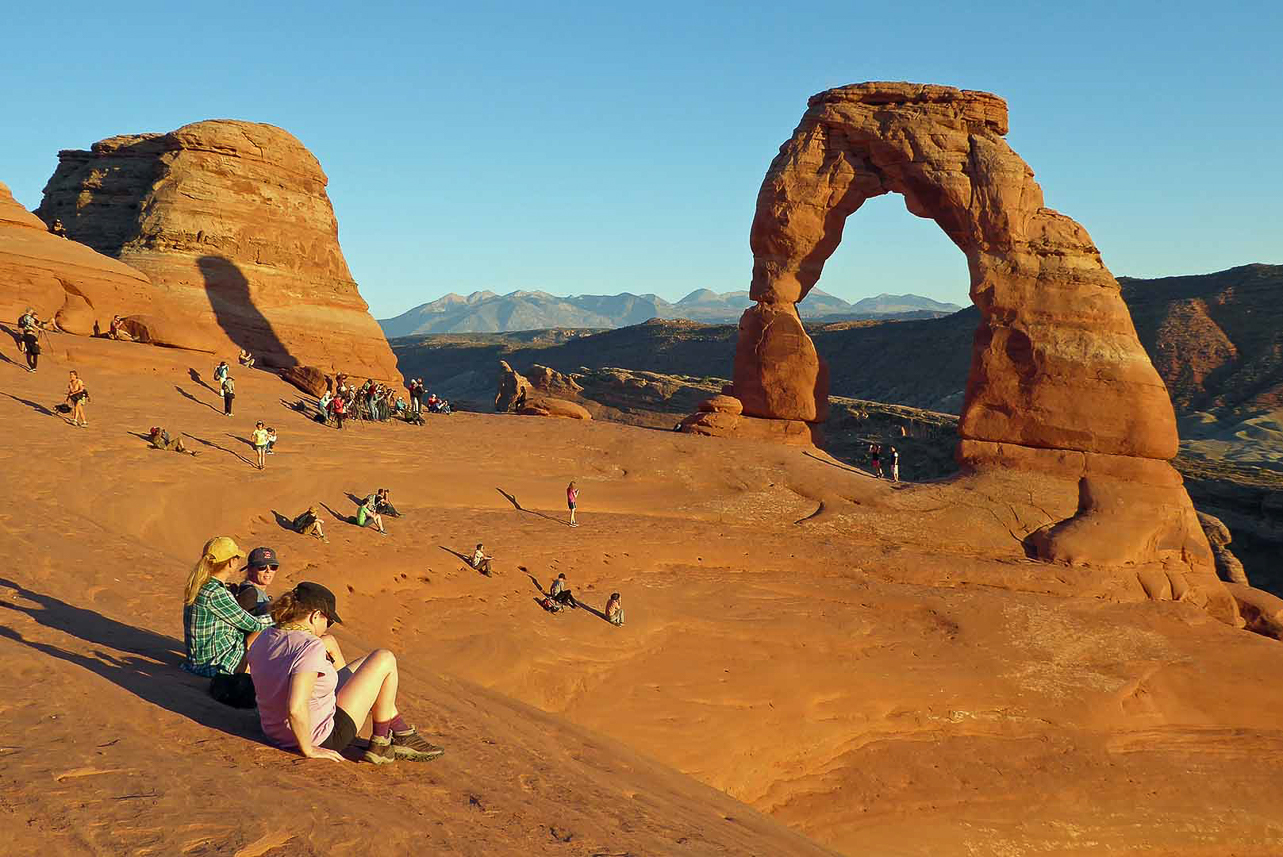 Delicate Arch (Utah symbol) at sunset, popular place rquiring one hour walk upwards